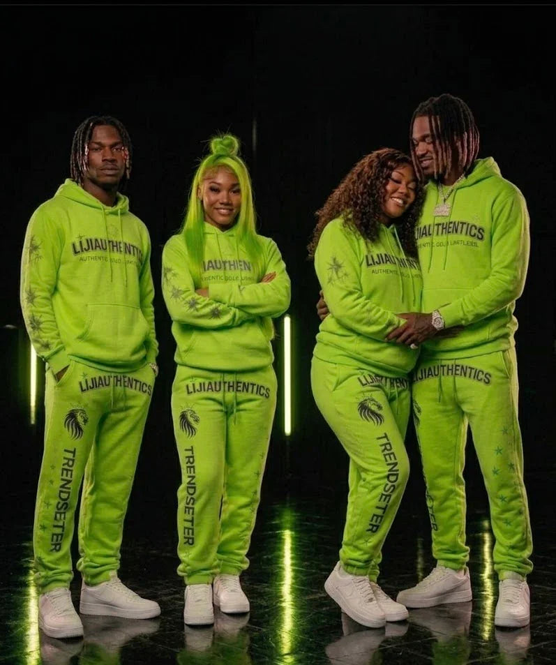 Vibrant neon green matching sweatsuits with bold branding, worn by four models in a stylish streetwear set.
